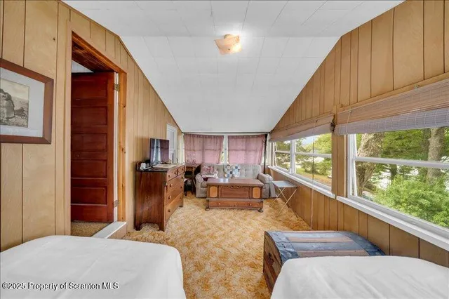 a bedroom with furniture and large windows