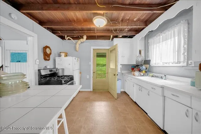 a kitchen with stainless steel appliances a stove a sink and a refrigerator