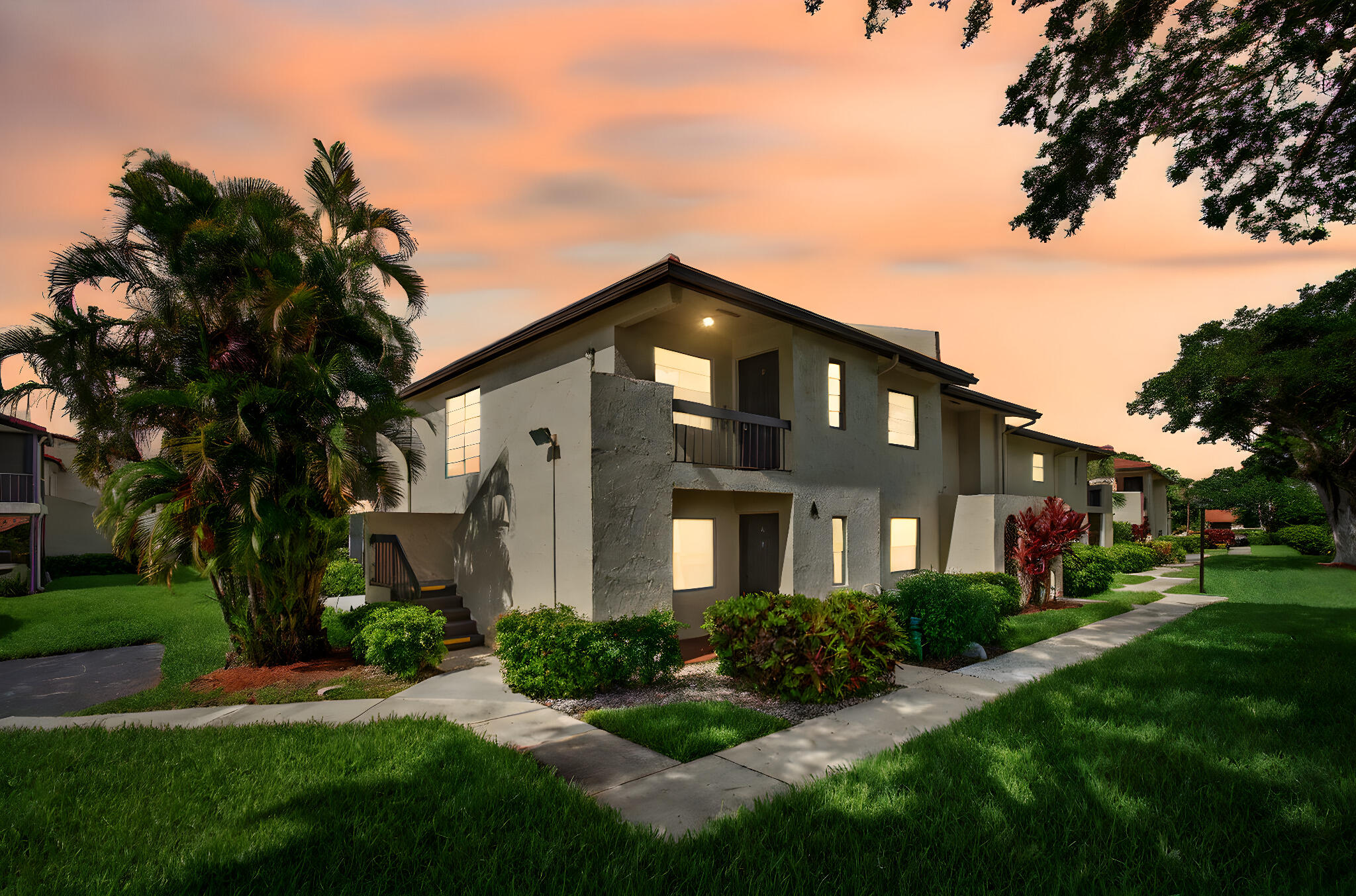 8536 Casa Del Lago, Unit 49B Boca Raton, FL 33433 - Photo 4 of 79 a front view of a house with a yard and trees