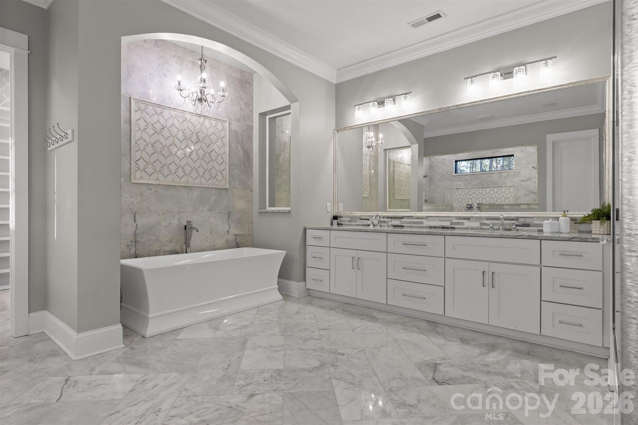 135 Stillwater Road Troutman, NC 28166 - Photo 12 of 43 a spacious bathroom with a tub sink and mirror