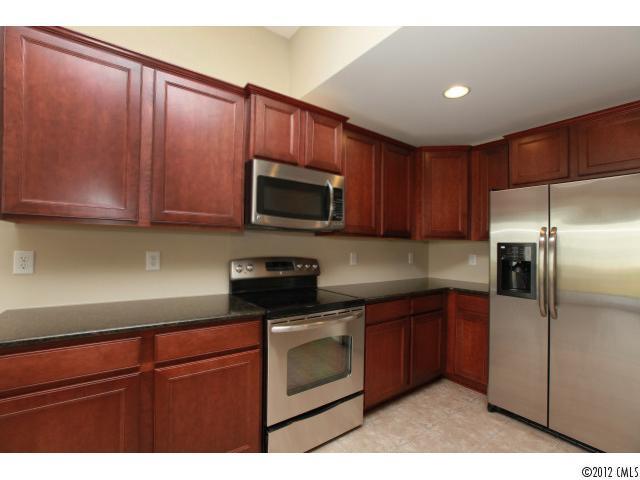 2203 Durand Road, Unit 79 Fort Mill, SC 29715 - Photo 3 of 12 a kitchen with a sink a microwave and cabinets