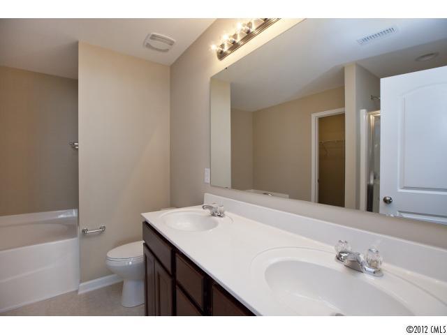 2203 Durand Road, Unit 79 Fort Mill, SC 29715 - Photo 9 of 12 a bathroom with a sink vanity granite and a toilet