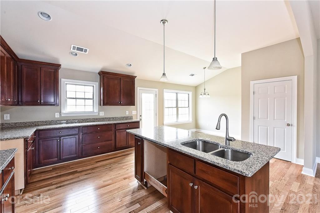 3406 Sincerity Road, Unit 3 Monroe, NC 28110 - Photo 14 of 27 a kitchen with granite countertop a sink a counter space appliances and cabinets