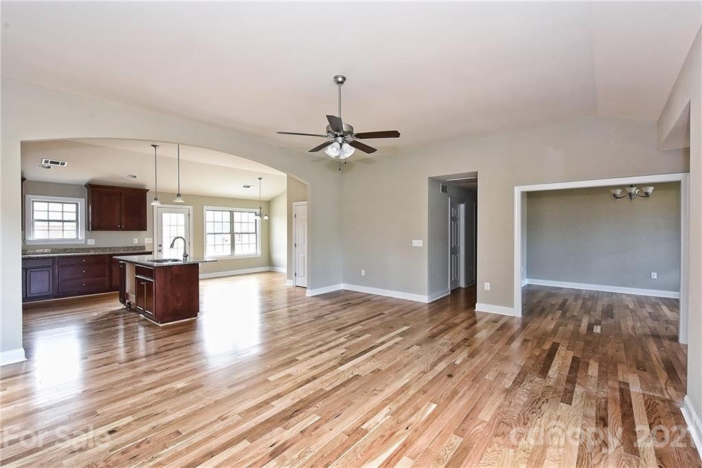 3406 Sincerity Road, Unit 3 Monroe, NC 28110 - Photo 7 of 27 a view of an empty room with window and wooden floor