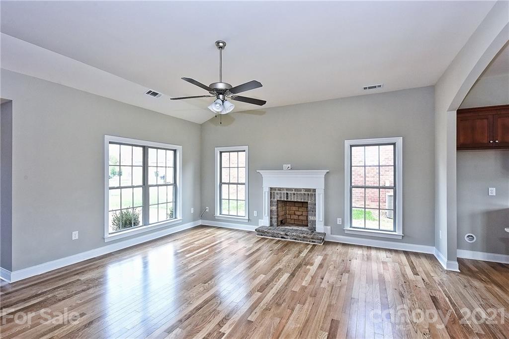 3406 Sincerity Road, Unit 3 Monroe, NC 28110 - Photo 10 of 27 a view of an empty room with wooden floor and a window