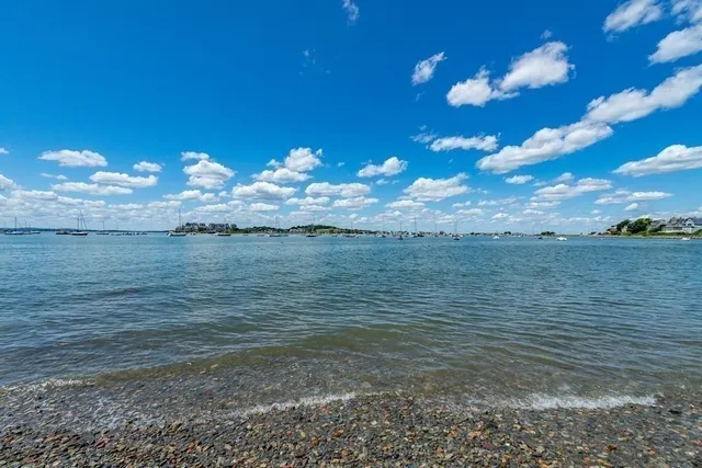 a bathroom with a granite countertop sink mirror vanity and toilet