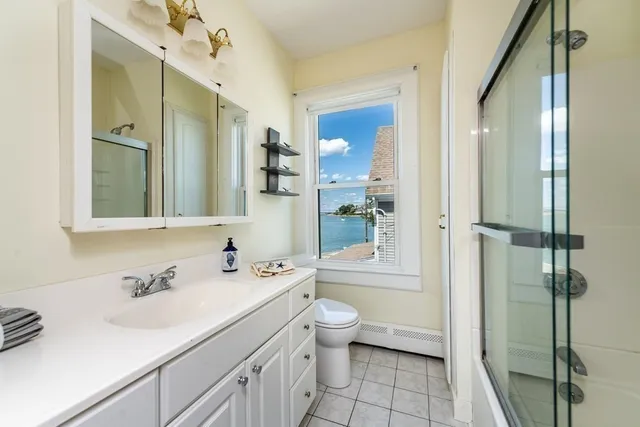 a view of a balcony with wooden floor and outdoor seating