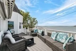 a balcony with furniture and a potted plant