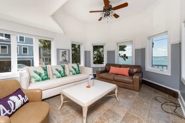 a living room with furniture ceiling fan and a rug