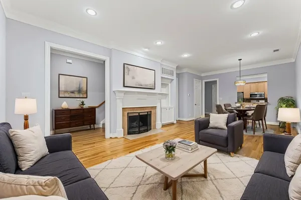 a living room with furniture fireplace and window