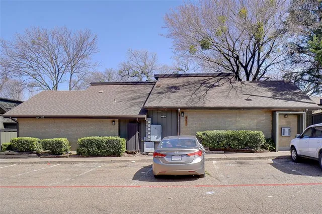 a house that has a tree in front of it