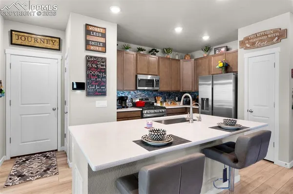 a kitchen with a table chairs and a refrigerator