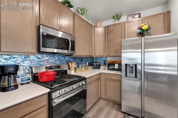 a kitchen with a refrigerator stove and microwave
