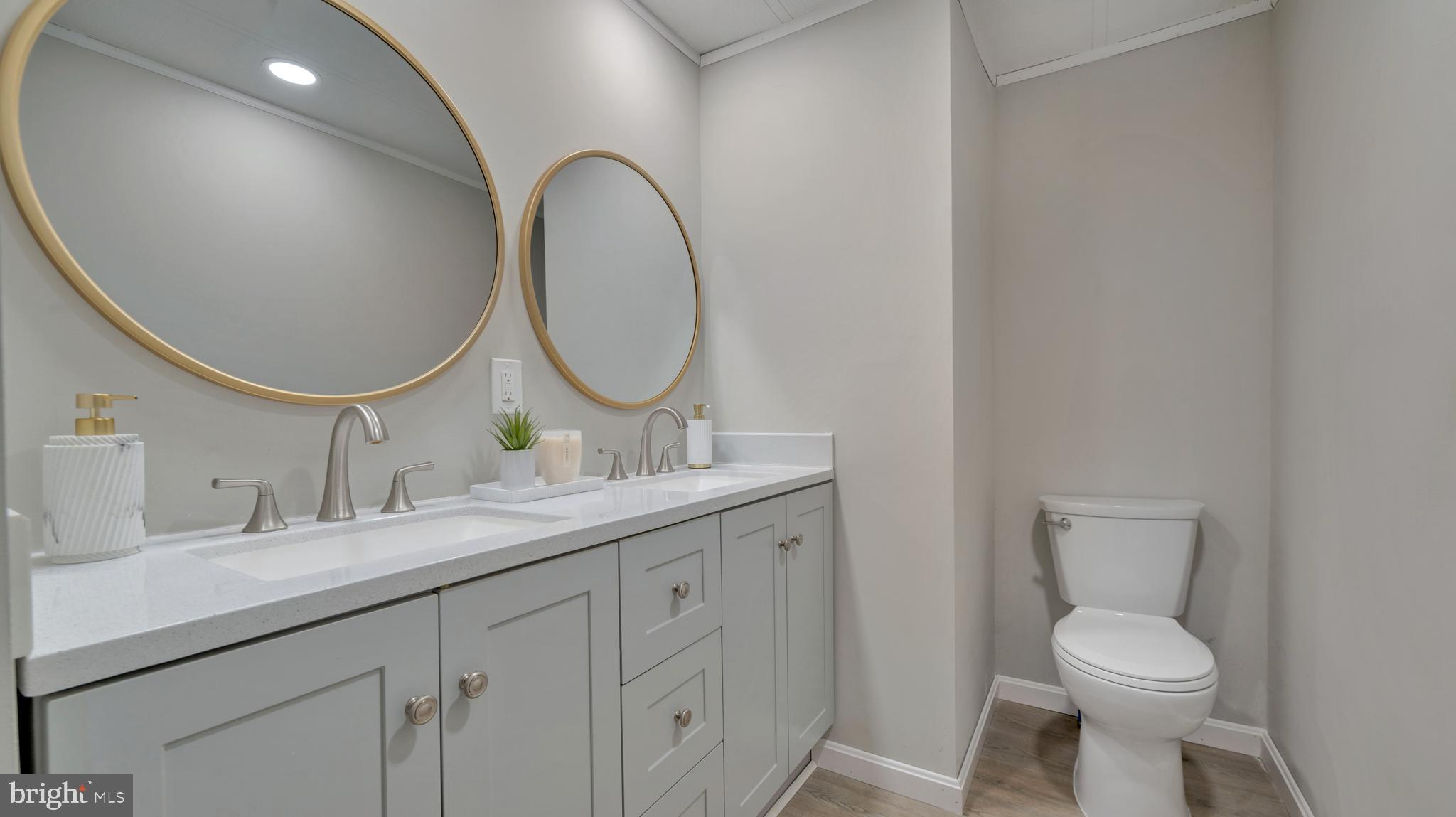 276 5th Street Lothian, MD 20711 - Photo 11 of 18 a bathroom with a toilet sink and mirror