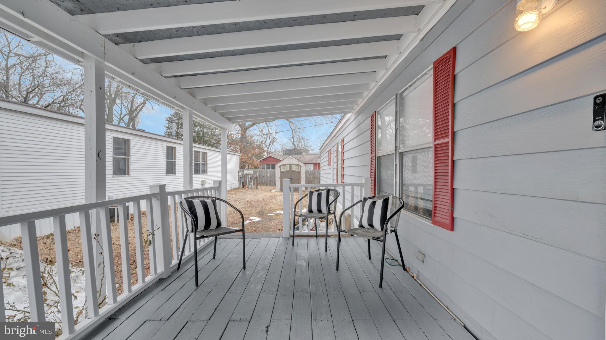 276 5th Street Lothian, MD 20711 - Photo 15 of 18 a view of balcony with chairs and wooden floor