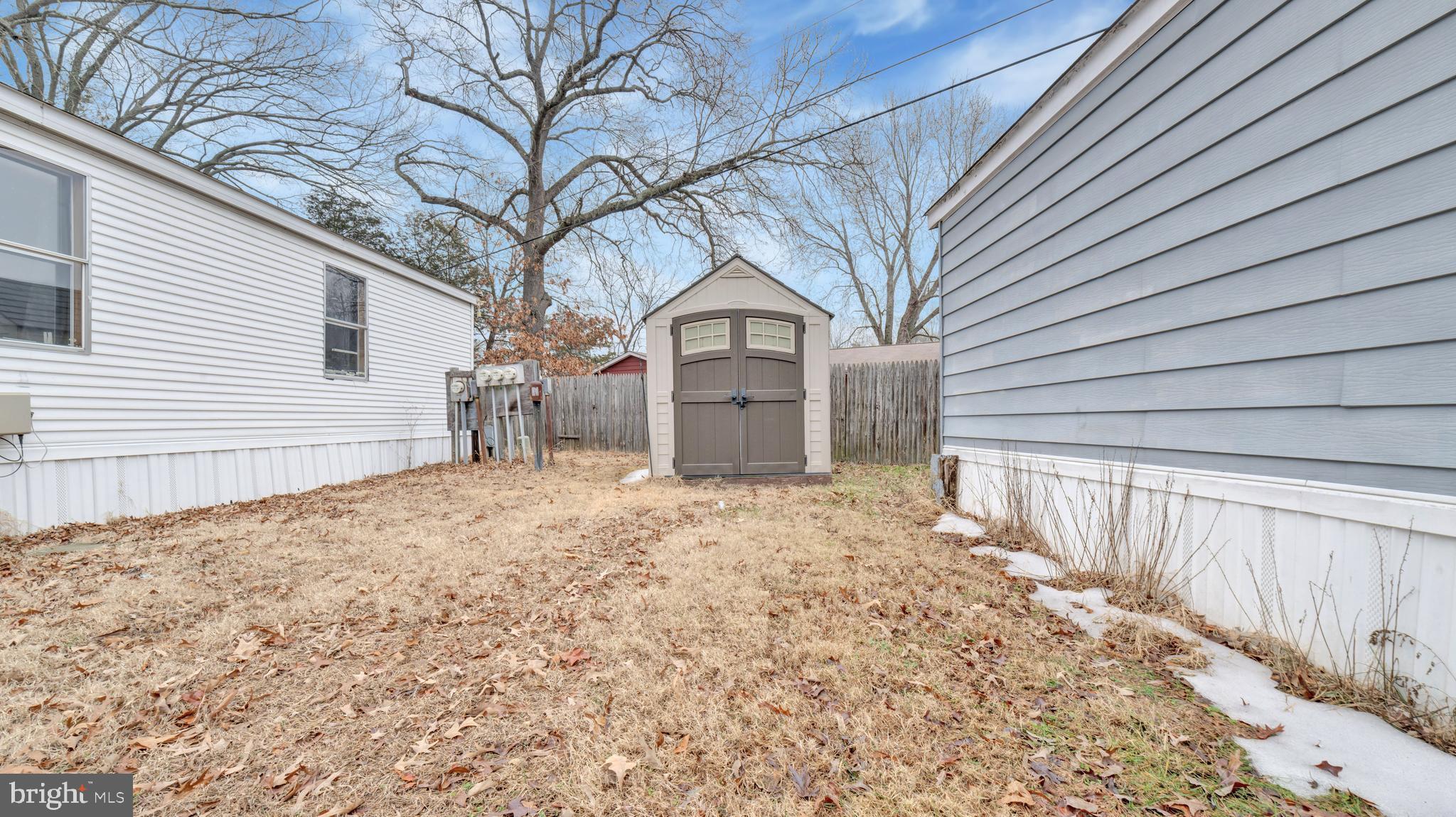 276 5th Street Lothian, MD 20711 - Photo 16 of 18 a front view of a house with a yard and garage