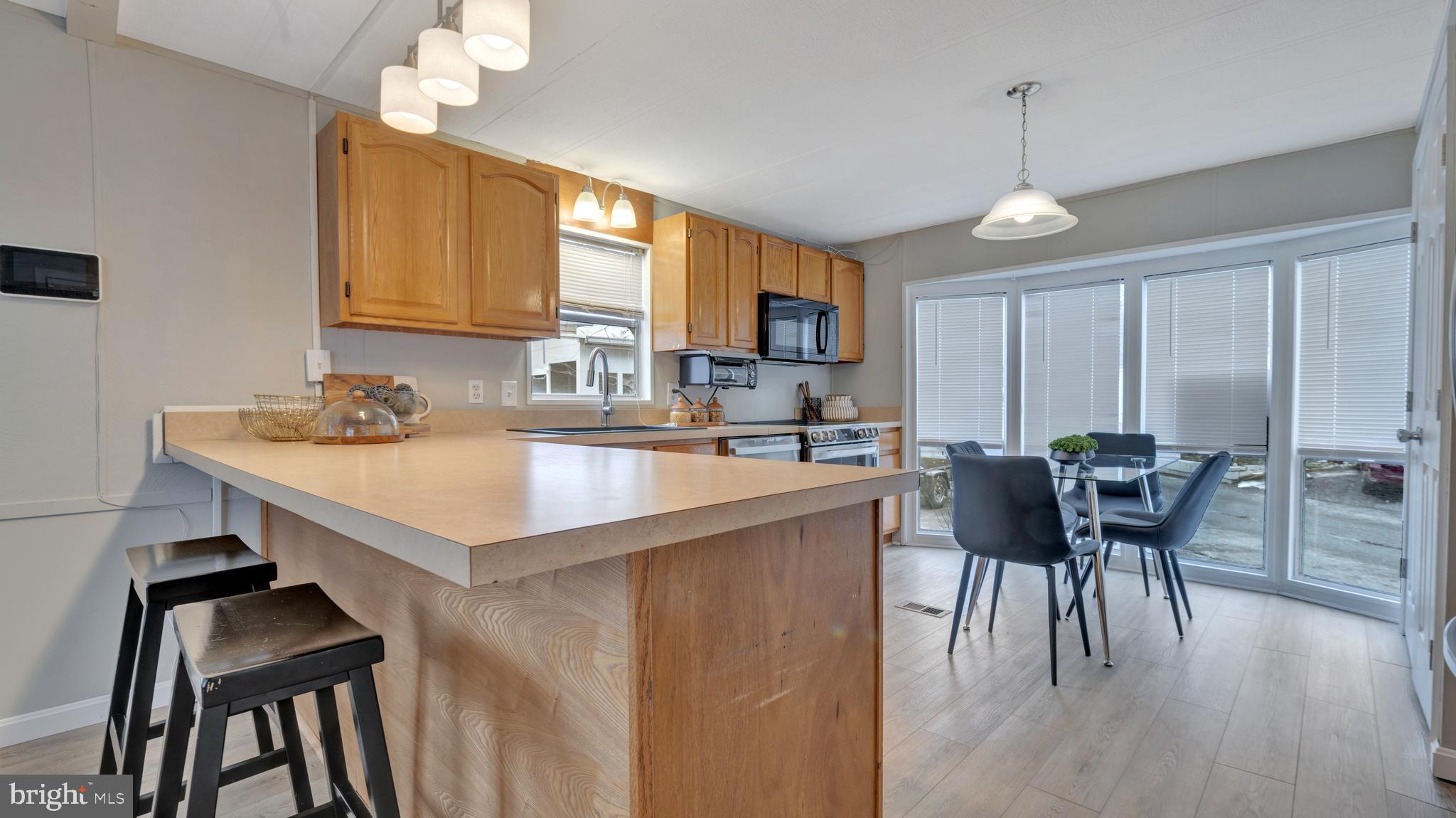 276 5th Street Lothian, MD 20711 - Photo 5 of 18 a kitchen with a dining table chairs and white cabinets