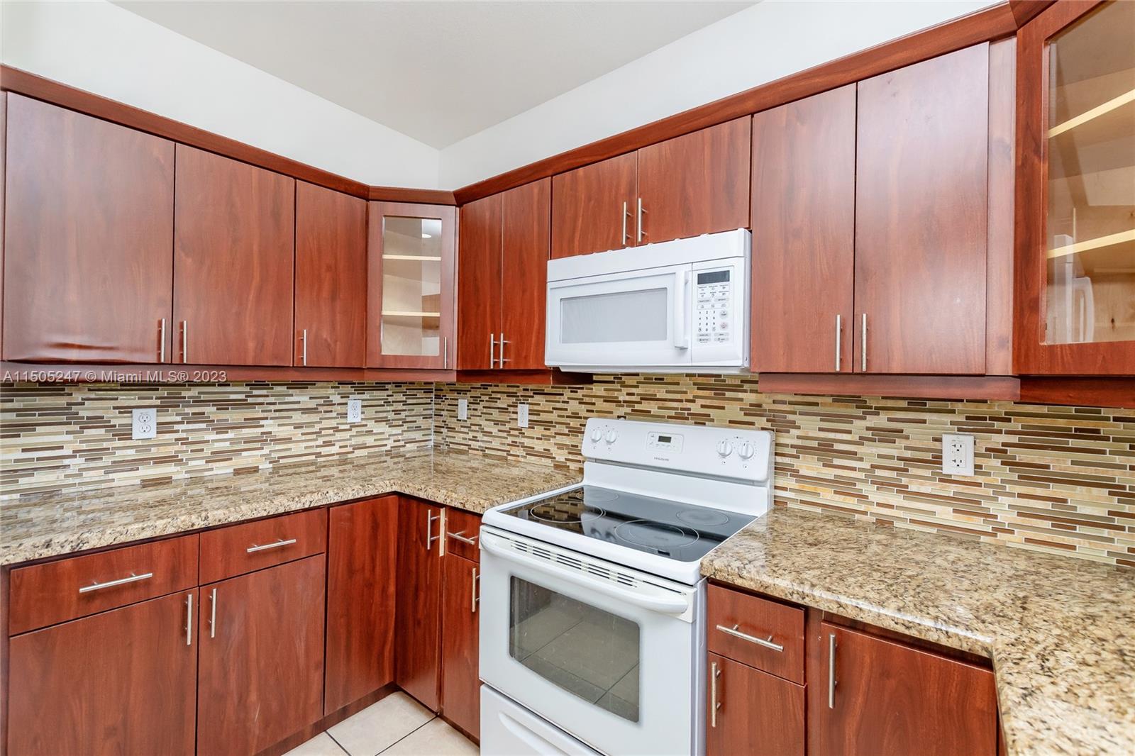 3501 Northeast 4th Street, Unit 3501 Homestead, FL 33033 - Photo 14 of 44 a kitchen with granite countertop cabinets sink and stainless steel appliances