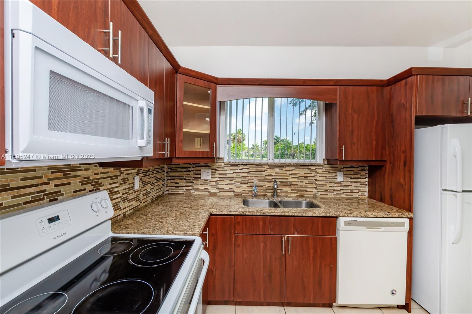3501 Northeast 4th Street, Unit 3501 Homestead, FL 33033 - Photo 15 of 44 a kitchen with granite countertop cabinets and window