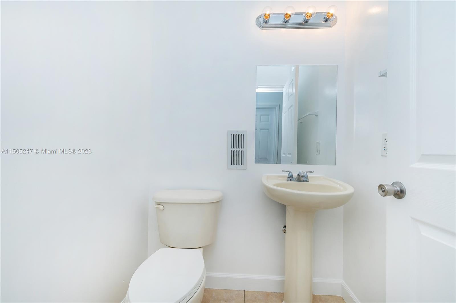 3501 Northeast 4th Street, Unit 3501 Homestead, FL 33033 - Photo 21 of 44 a bathroom with a toilet sink and mirror