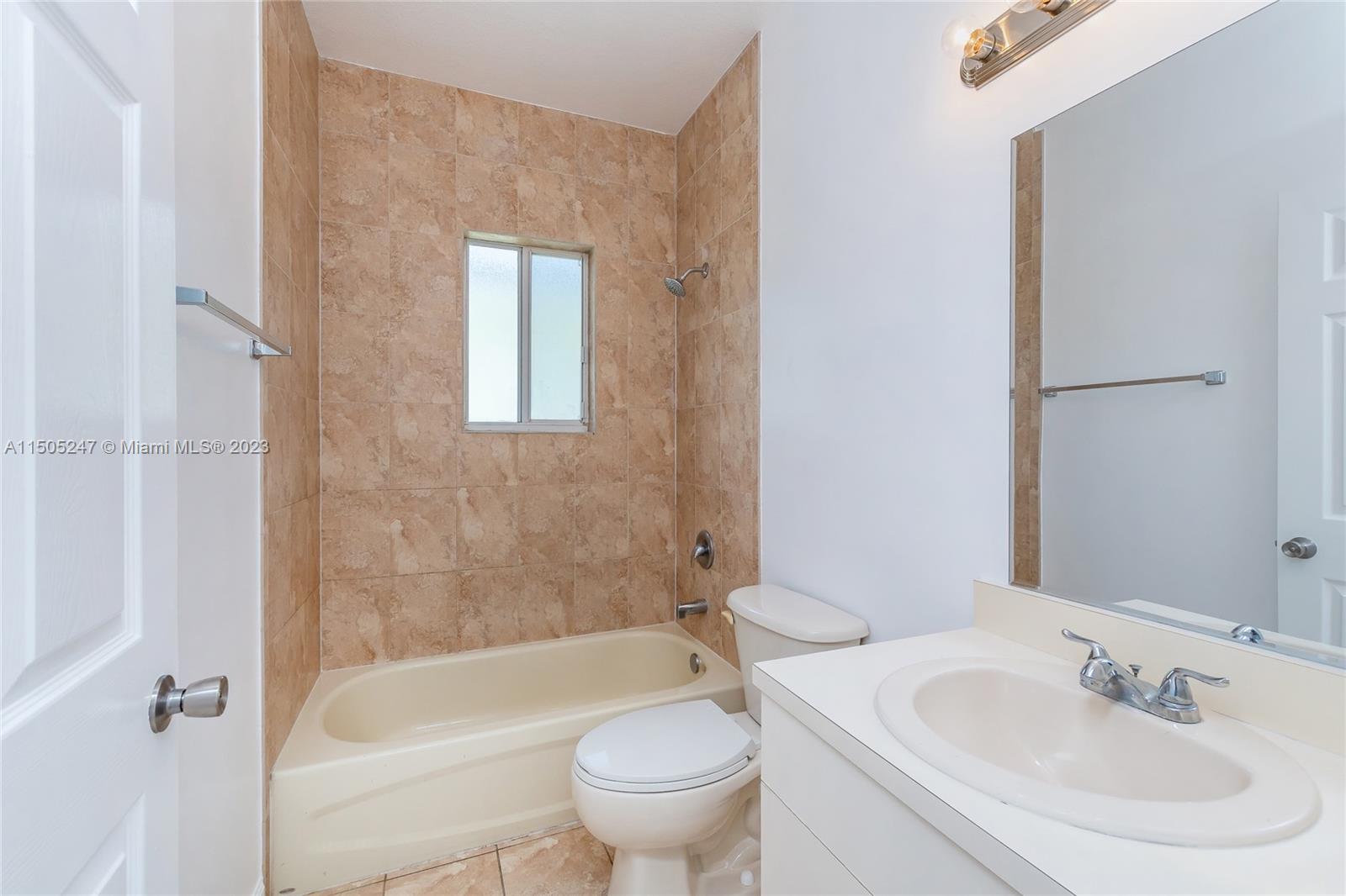 3501 Northeast 4th Street, Unit 3501 Homestead, FL 33033 - Photo 24 of 44 a bath room with a toilet a sink and a bath tub