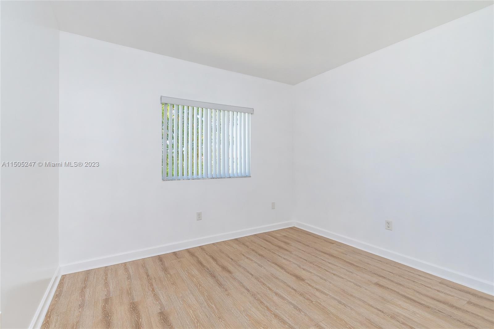 3501 Northeast 4th Street, Unit 3501 Homestead, FL 33033 - Photo 25 of 44 a view of an empty room with wooden floor and a window
