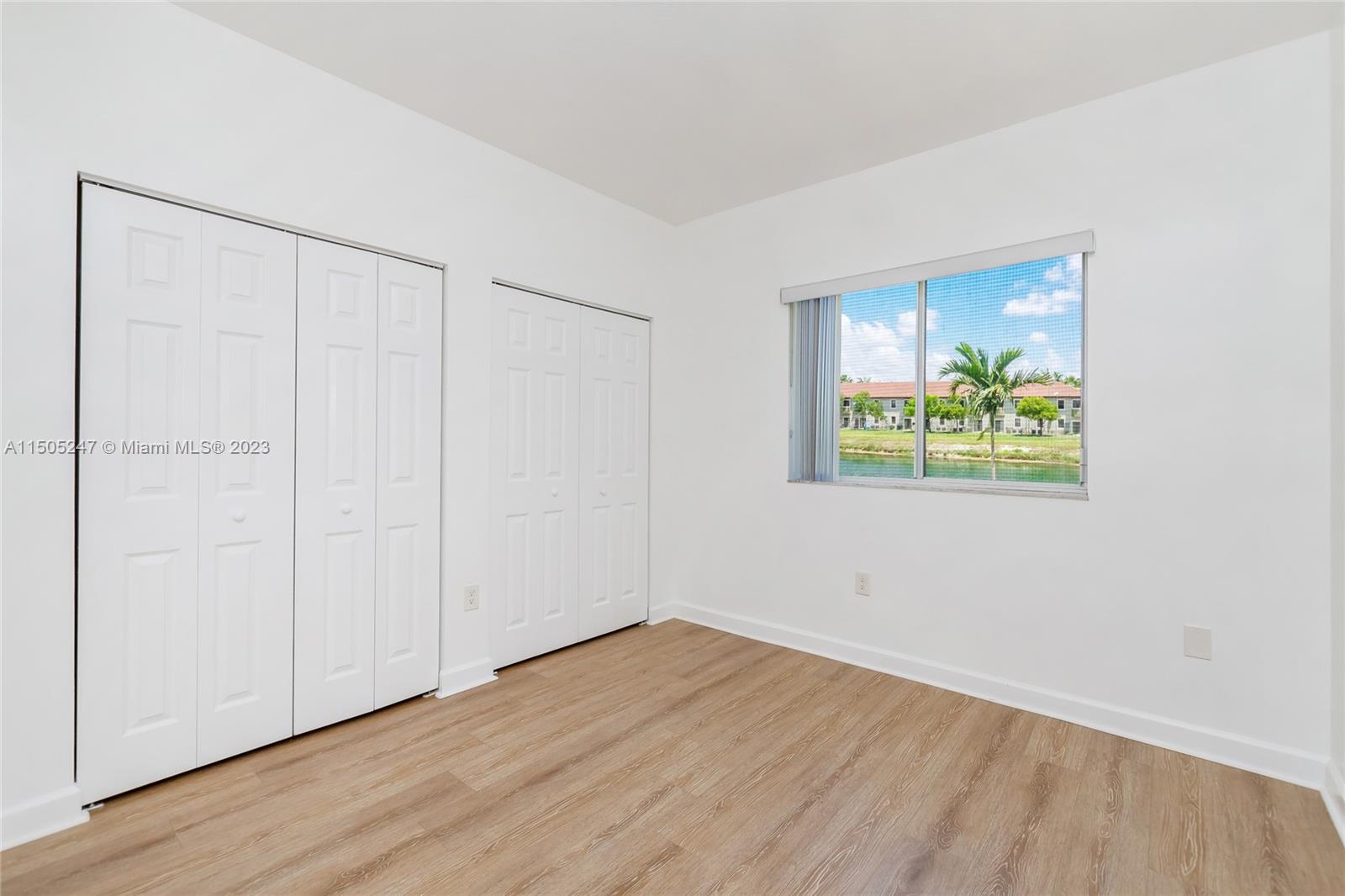 3501 Northeast 4th Street, Unit 3501 Homestead, FL 33033 - Photo 27 of 44 an empty room with wooden floor and windows