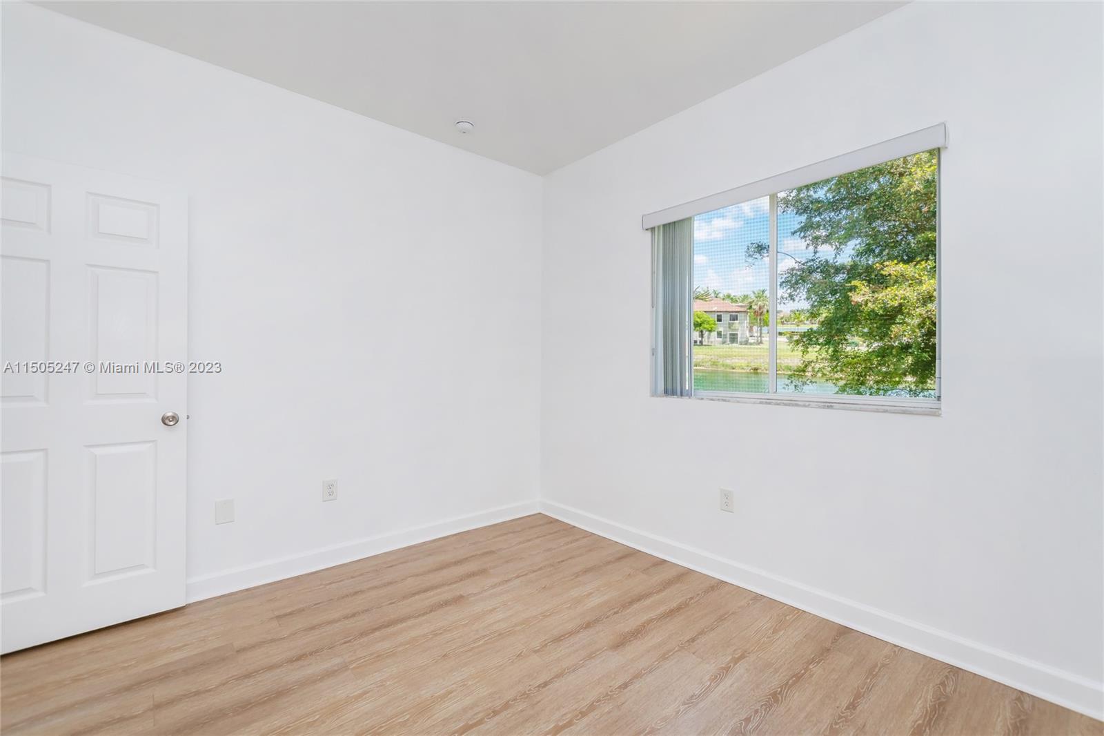3501 Northeast 4th Street, Unit 3501 Homestead, FL 33033 - Photo 28 of 44 an empty room with wooden floor and windows