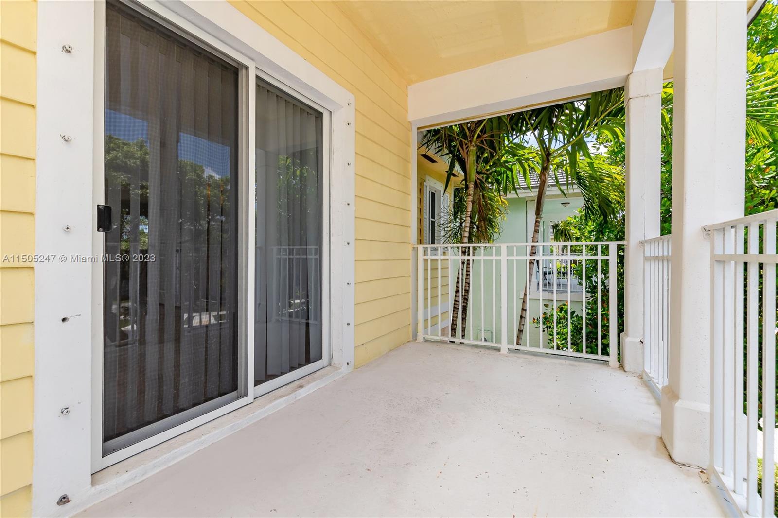 3501 Northeast 4th Street, Unit 3501 Homestead, FL 33033 - Photo 30 of 44 a view of a porch with wooden floor and front door