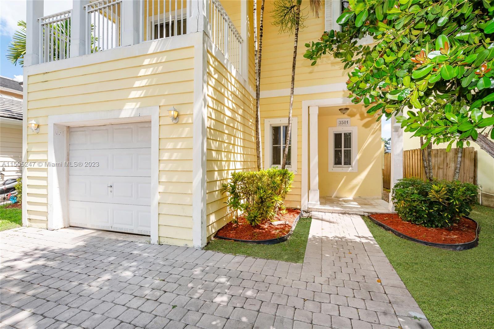 3501 Northeast 4th Street, Unit 3501 Homestead, FL 33033 - Photo 3 of 44 a view of a house with a small yard and a large tree front of it