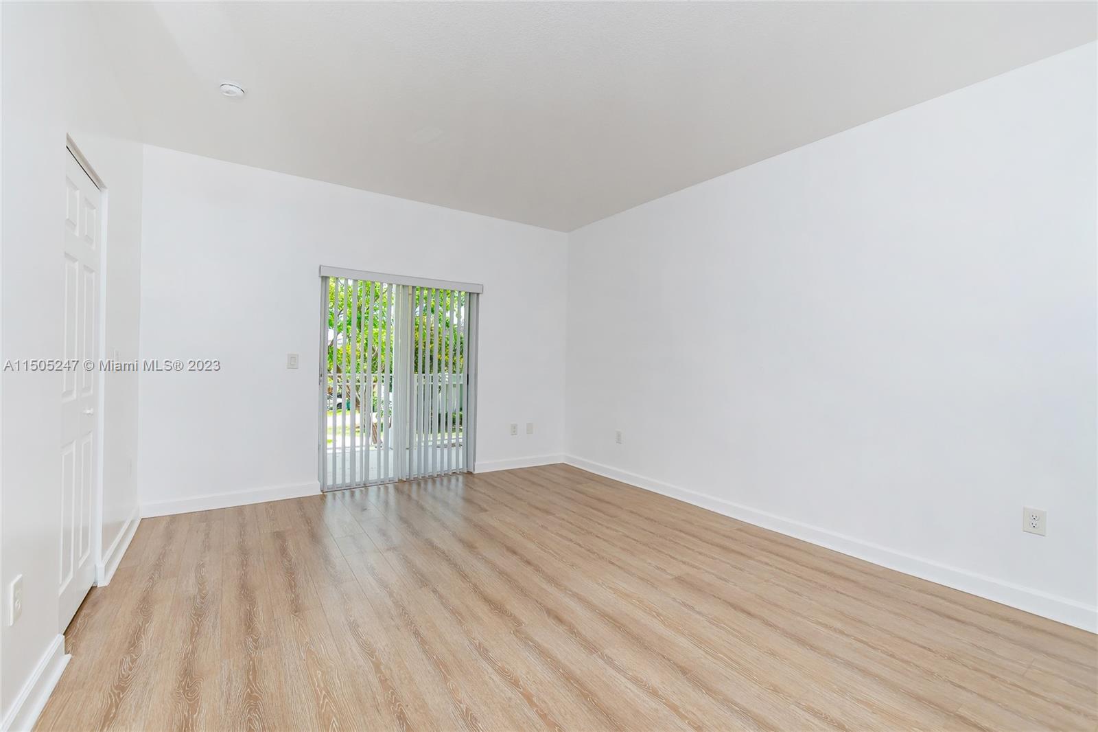 3501 Northeast 4th Street, Unit 3501 Homestead, FL 33033 - Photo 31 of 44 a view of an empty room with wooden floor and a window