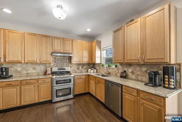 a kitchen with a sink a window and cabinets