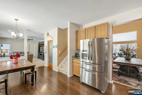 a kitchen with stainless steel appliances a refrigerator and wooden floor