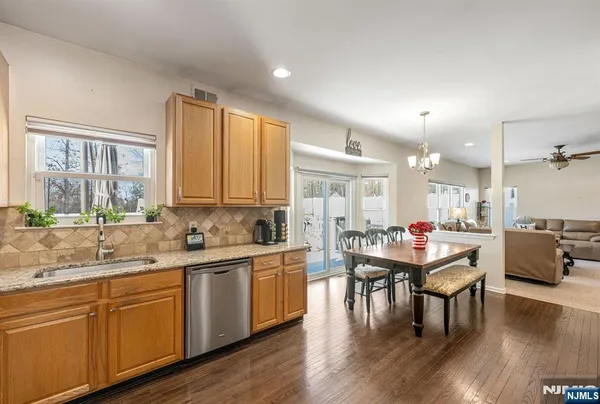 a kitchen with a sink cabinets and wooden floor