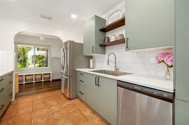 a kitchen with stainless steel appliances a sink stove and cabinets