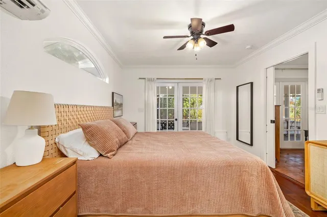 a bedroom with a bed and a large window