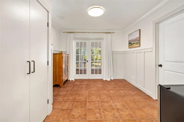 a dining room with wooden floor glass table and windows