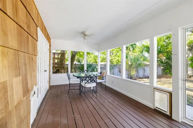 a living room with furniture and large windows