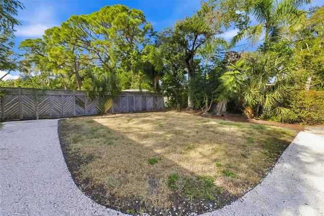an aerial view of a house with a yard swimming pool and outdoor seating