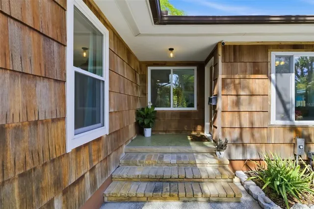 a view of a house with a large window and wooden floor