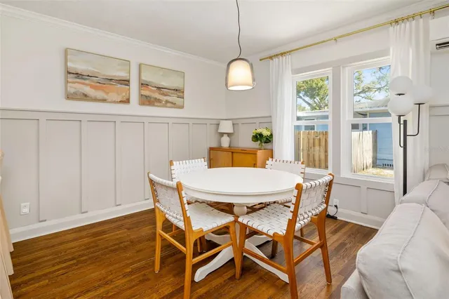 a view of a dining room with furniture wooden floor and chandelier