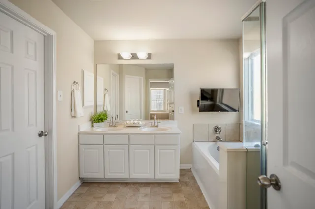 a room with a sink and a mirror