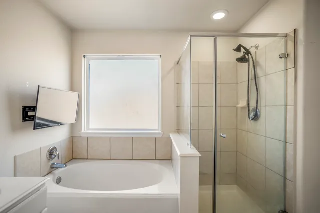a bathroom with a bathtub and a shower