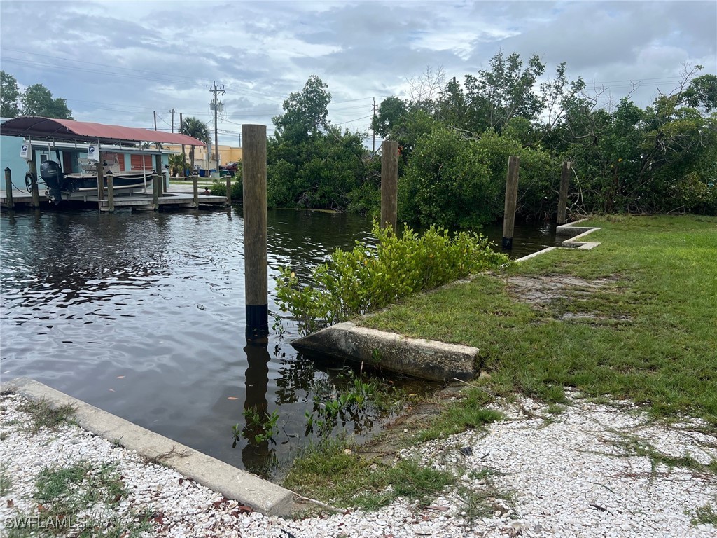 11458 May Street, Unit 1 Matlacha, FL 33993 - Photo 11 of 18 a view of a lake with a building in the background