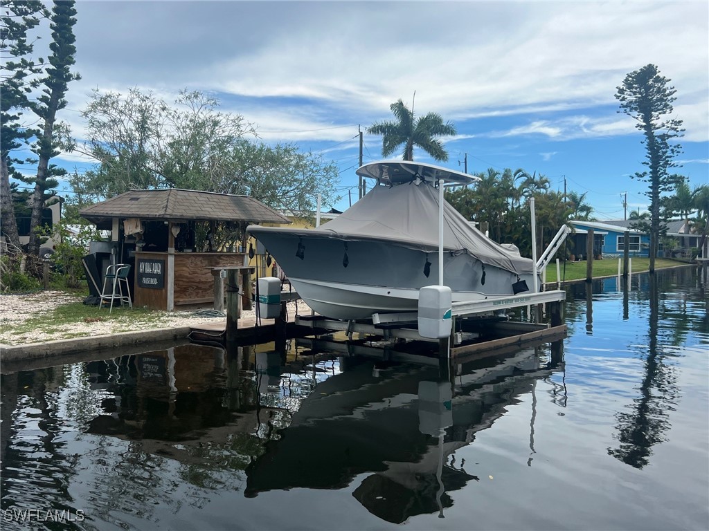11458 May Street, Unit 1 Matlacha, FL 33993 - Photo 12 of 18 a view of house with wooden deck and furniture