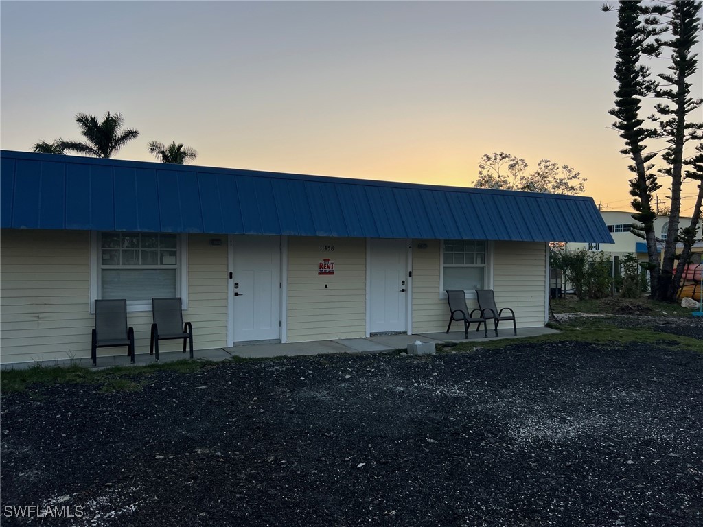 11458 May Street, Unit 1 Matlacha, FL 33993 - Photo 2 of 18 a backyard of a house with table and chairs