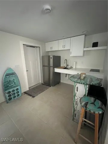 a kitchen with a refrigerator and cabinets