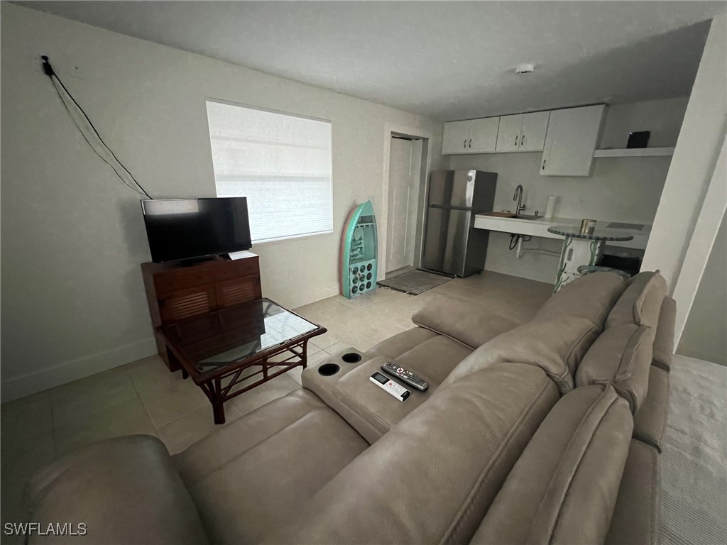 11458 May Street, Unit 1 Matlacha, FL 33993 - Photo 7 of 18 a living room with furniture and a flat screen tv
