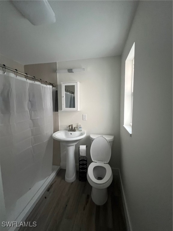 11458 May Street, Unit 1 Matlacha, FL 33993 - Photo 8 of 18 a bathroom with a sink toilet and shower