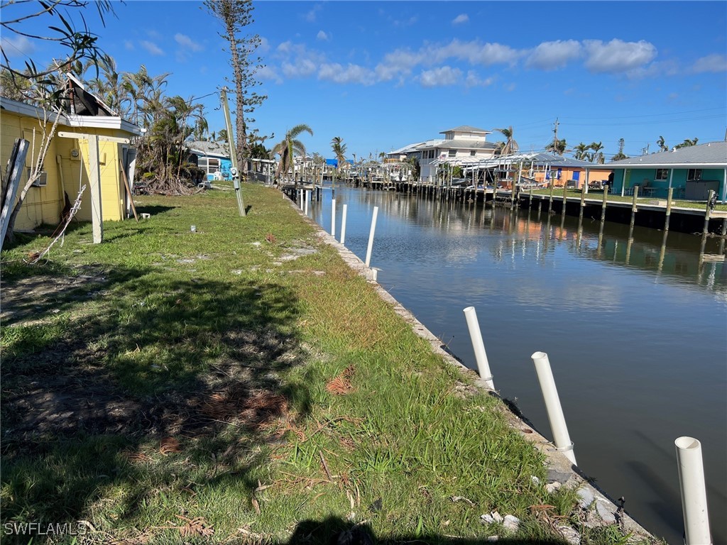 11458 May Street, Unit 1 Matlacha, FL 33993 - Photo 10 of 18 a view of a lake with boats and trees in the background